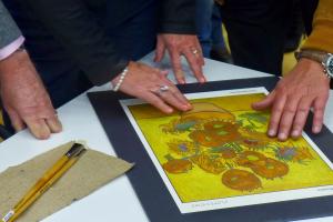 Voelbare tekening van de zonnebloemen van Van Gogh met tastende handen