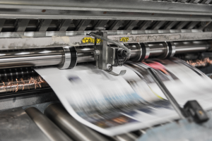 drukkerij printer waaruit een blad van een magazine uitrolt